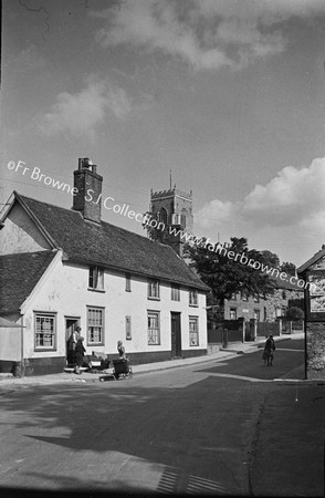 VILLAGE STREET WITH CHURCH TOWER